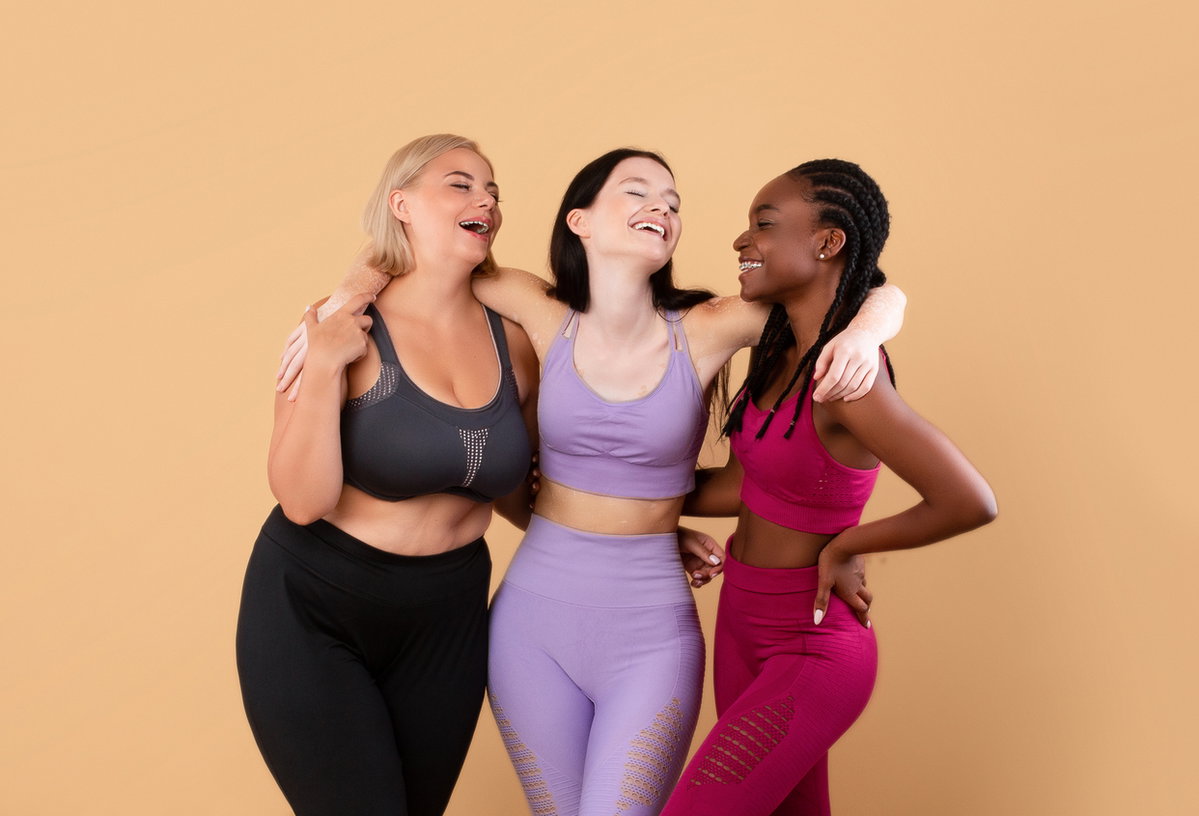 Fitnessfreundinnen mit unterschiedlichen Figuren nebeneinander