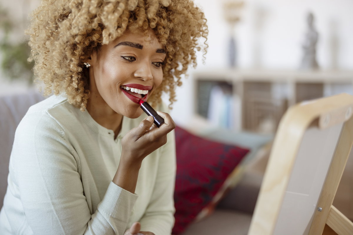 Frau trägt Lippenstift auf