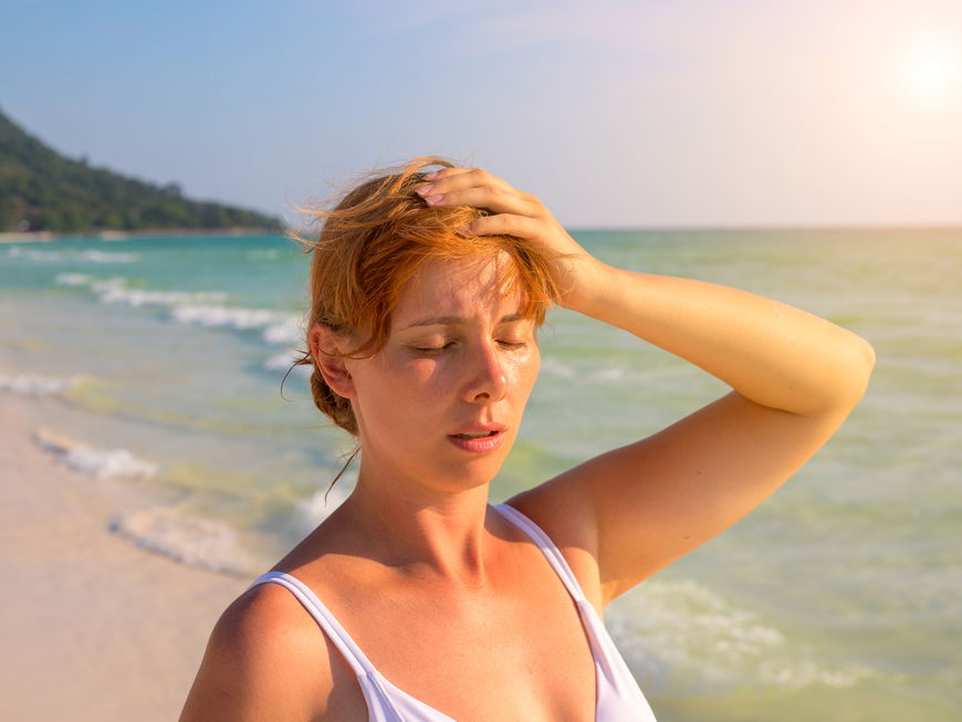 Frau steht in der Sonne