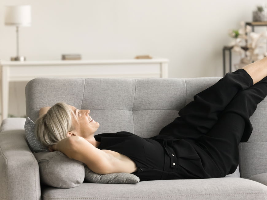 Frau liegt auf dem Sofa