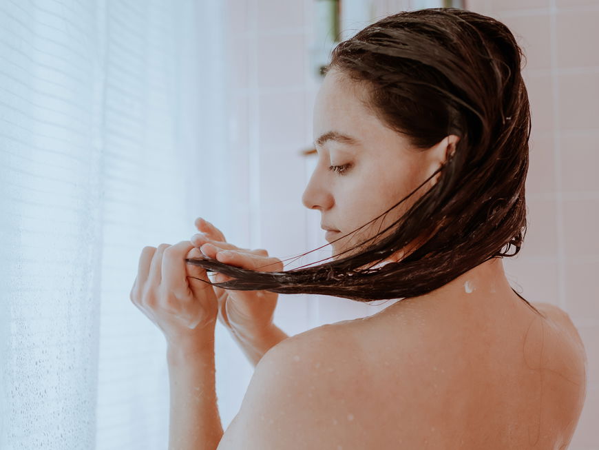 Frau wäscht ihre Haare