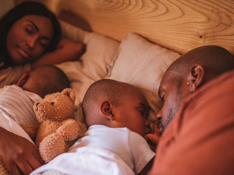 Familie schläft im Bett