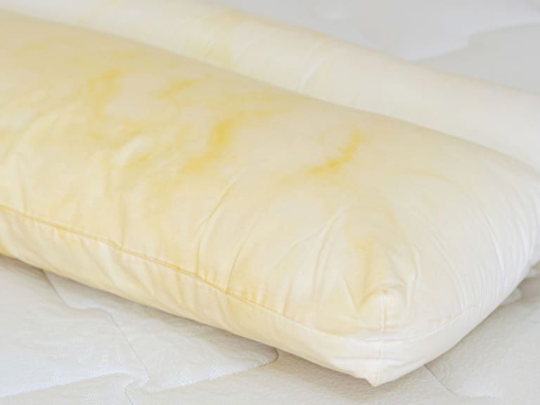 Gelbes Kissen auf dem Bett